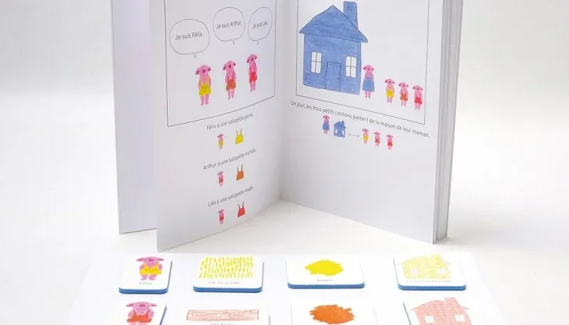 Livre ouvert des Trois Petits Cochons et cartes magnétiques du jeu